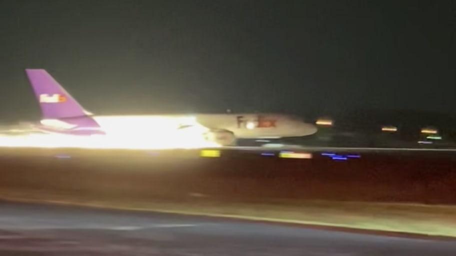 A FedEx plane skids along a runway in Tennessee after being forced to land without its landing gear deployed.