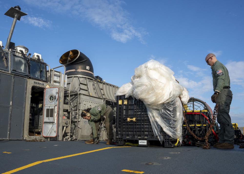 U.S. Navy personnel on Friday securing and transporting the remnants of a Chinese spy balloon