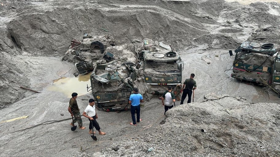 Members of Indian Army try to recover trucks buried at the area affected by flood in Sikkim in this undated image released by the Indian Army on October 5, 2023. 
