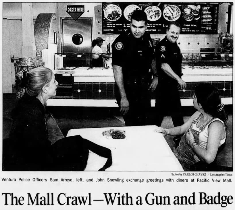 John Snowling smiling in a newspaper photo of him patrolling a mall.