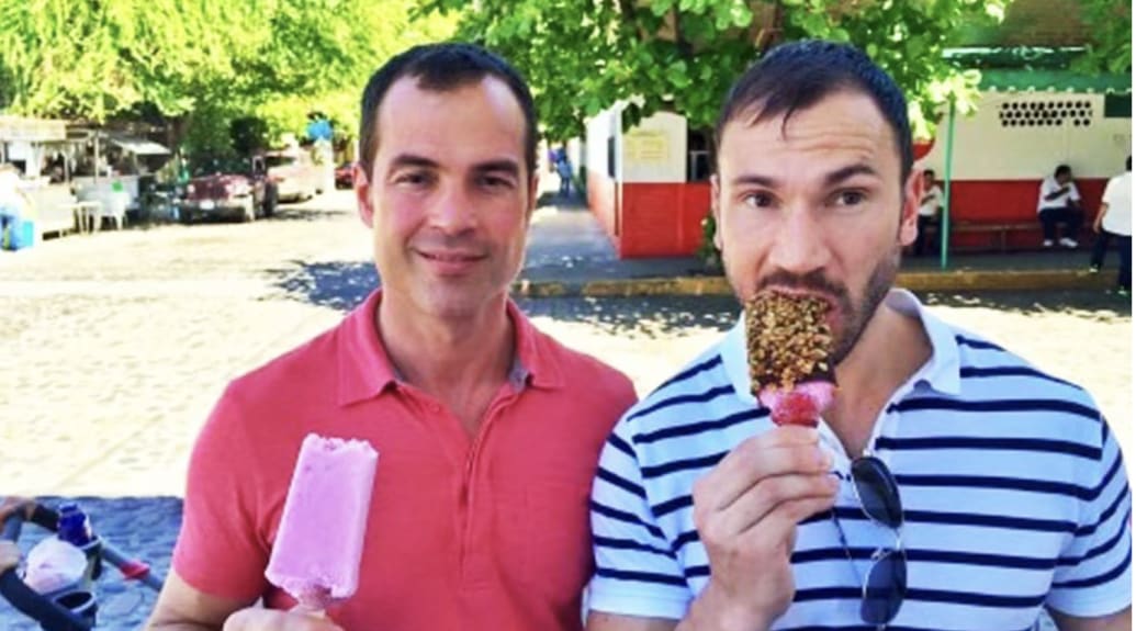 Devon, left, holds an ice cream while posing next to his friend