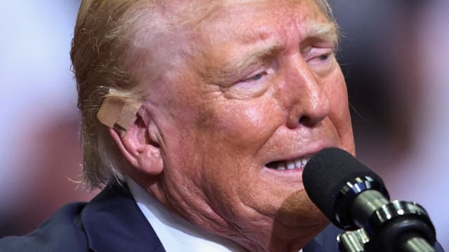 Republican presidential nominee and former U.S. President Donald Trump wears a flesh-colored bandage on his ear as he holds a campaign rally for the first time with his running mate.