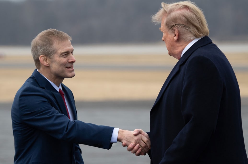 Donald Trump shakes hands with Jim Jordan as he disembarks from Air Force One.