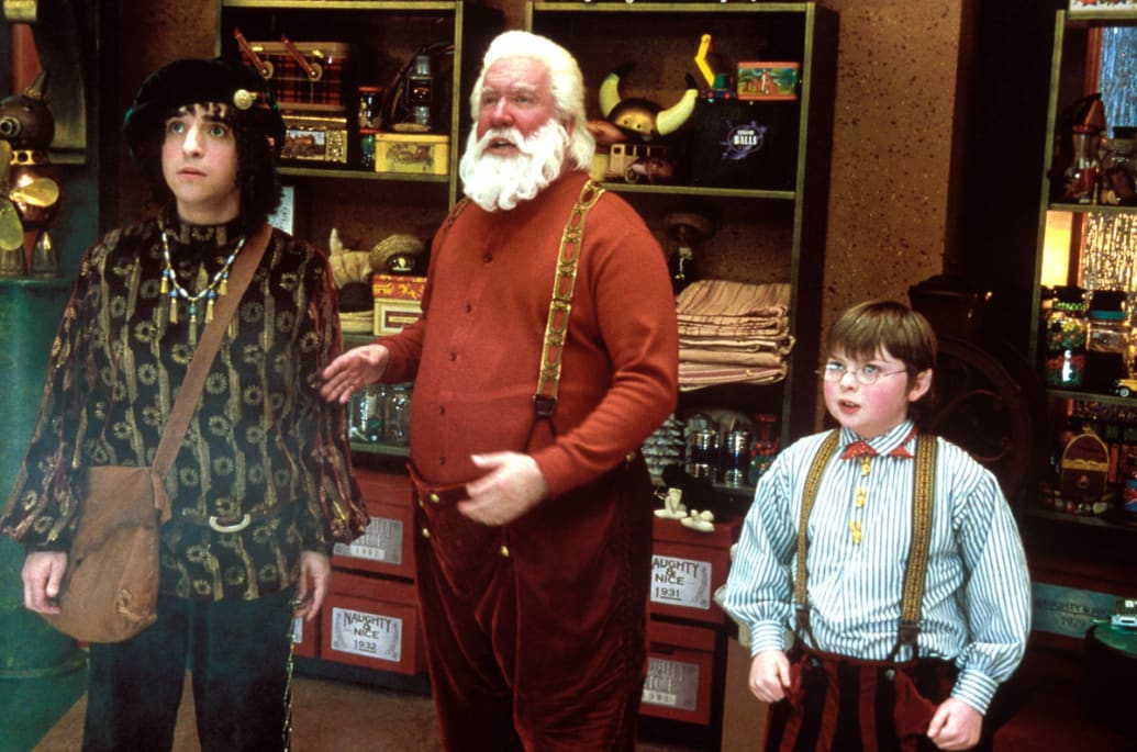 David Krumholtz, Tim Allen, Spencer Breslin stand next to each other in a still from ‘The Santa Clause 2’