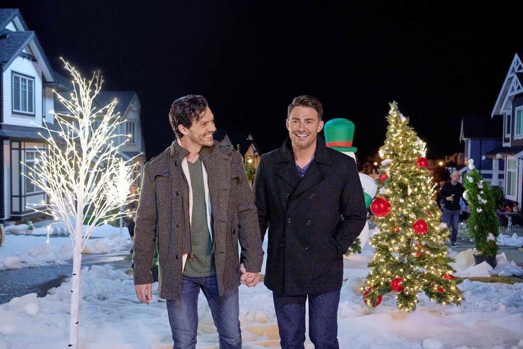 Jonathan Bennett and George Krissa hold hands in a still from ‘The Holiday Sitter’