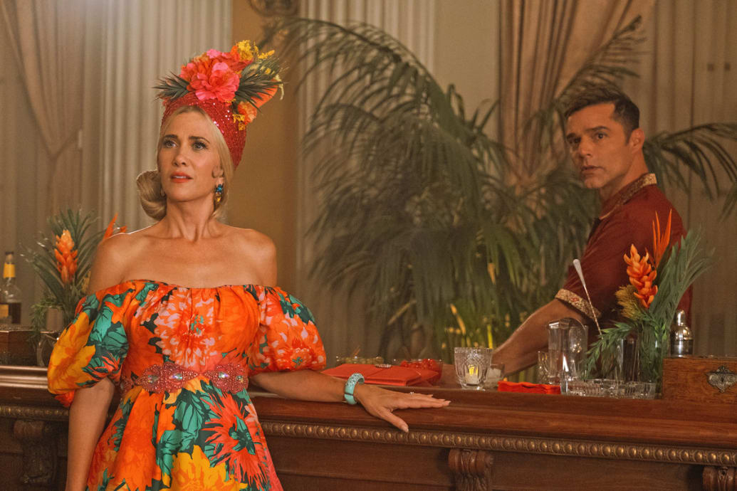 Kristen Wiig and Ricky Martin stand behind a bar in ‘Palm Royale’