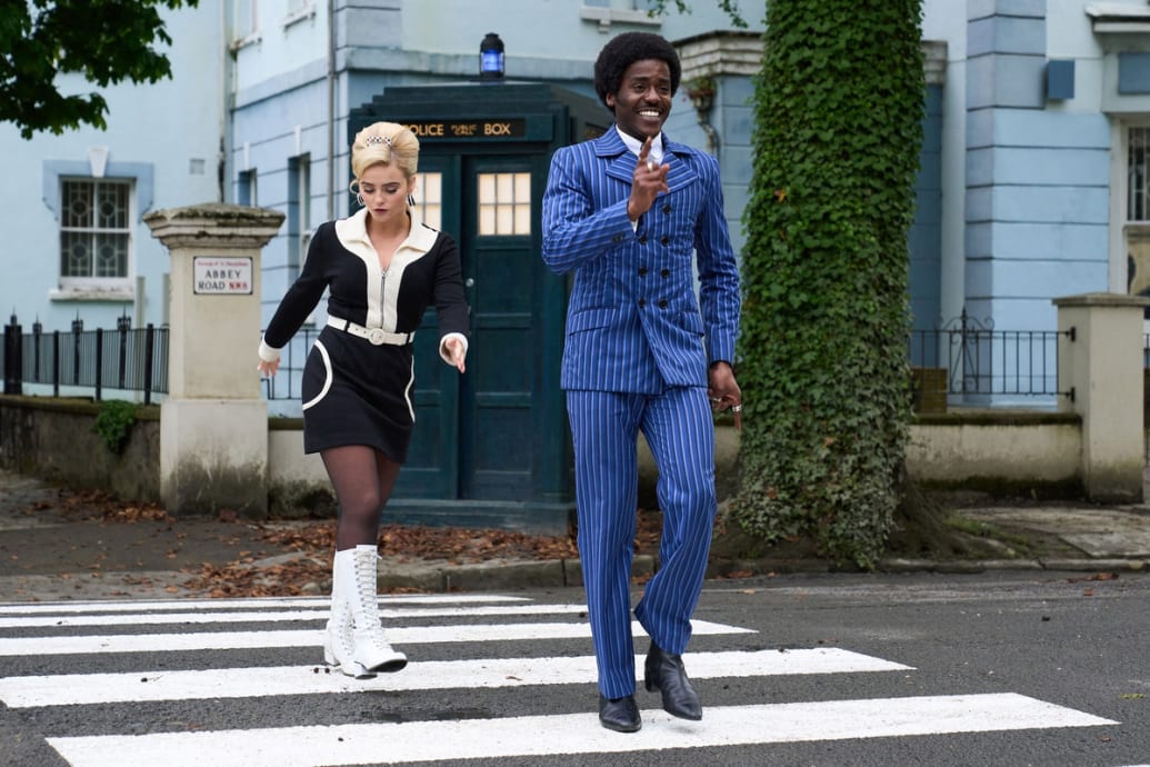 Ncuti Gatwa and Millie Gibson walk across the street in a still from ‘Doctor Who’