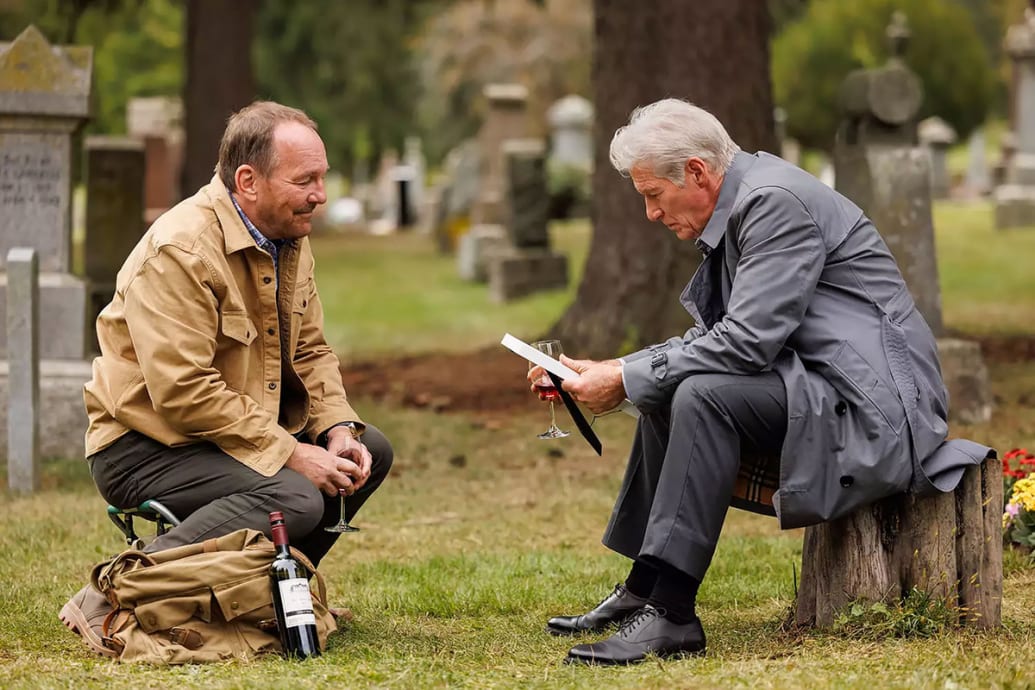 Larry Day kneels in front of a sitting Richard Gere in a still from ‘Longing’