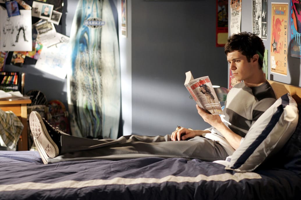 A picture of Adam Brody as Seth Cohen in ‘The O.C.' laying on a bed