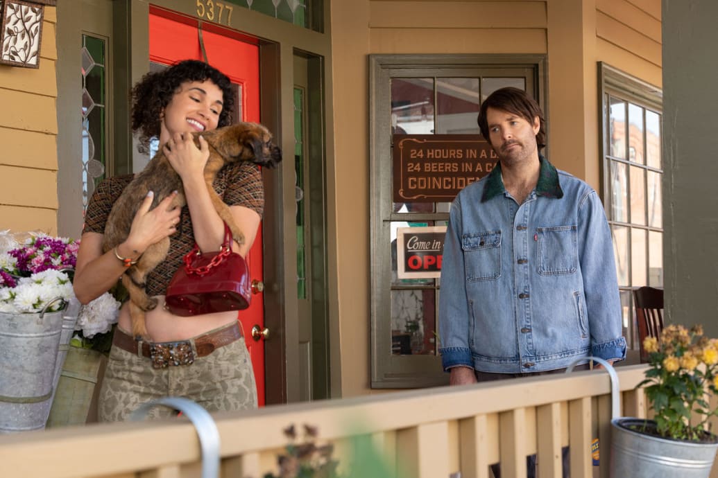 In a still from ‘Strays' Jade Marie Fernandez holds Reggie while Will Forte looks on