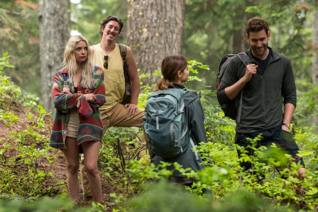 Ashley Benson, Eric Balfour, Jenna Coleman, and Oliver Jackson-Cohen in the woods in a still of ‘Wilderness’
