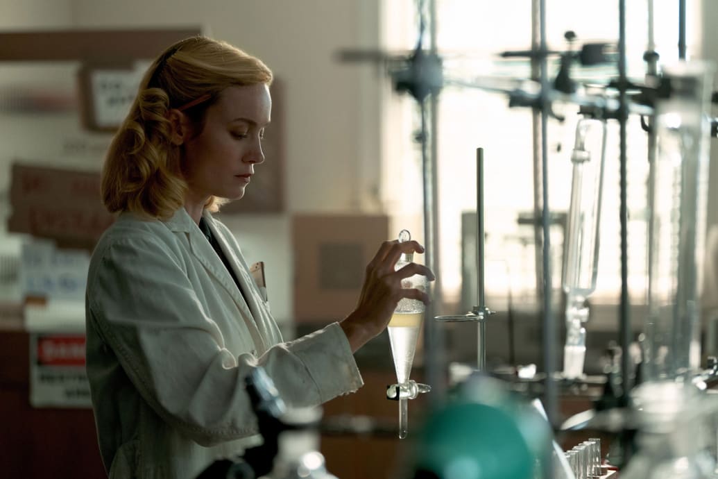 Brie Larson behind a chemistry set in a still from ‘Lessons in Chemistry’