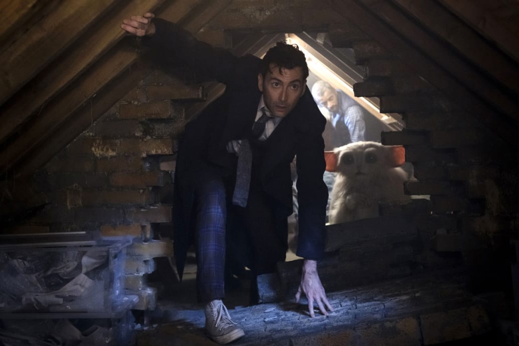 David Tennant as The Dr. crawls through a hole in an episode of the Dr. Who 60th anniversary special