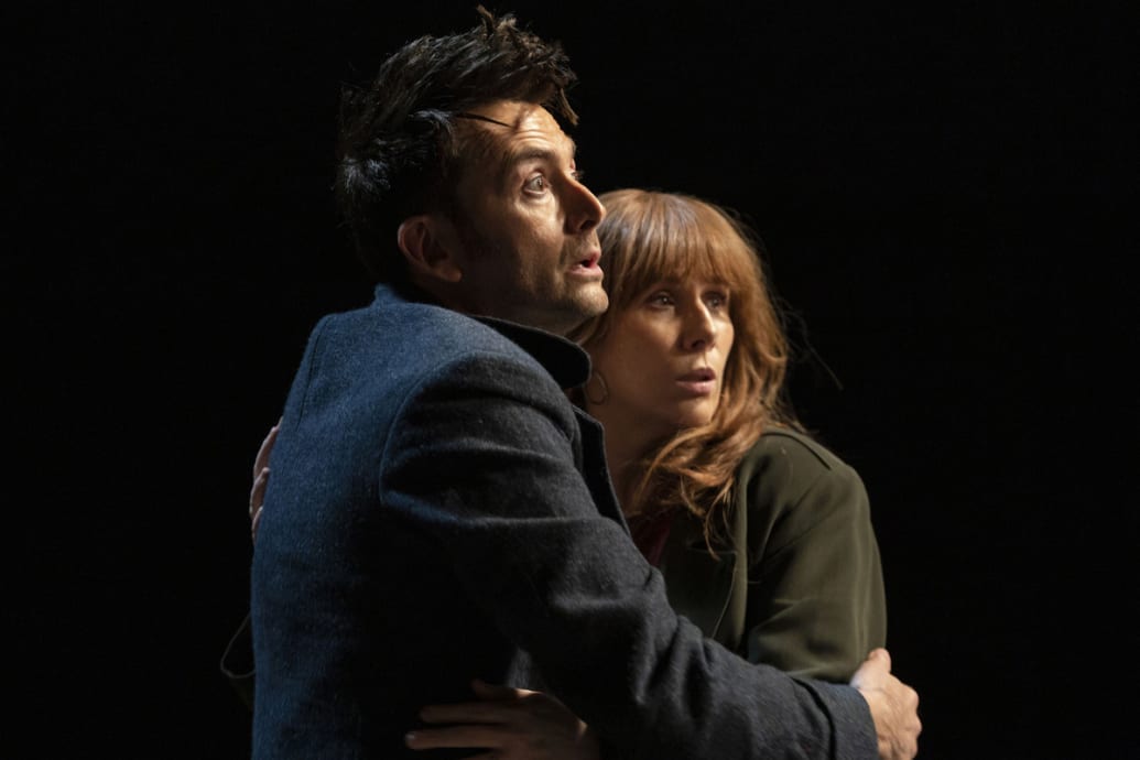 David Tennant and Catherine Tate hold each other in fear in an episode of the Dr. Who 60th anniversary special