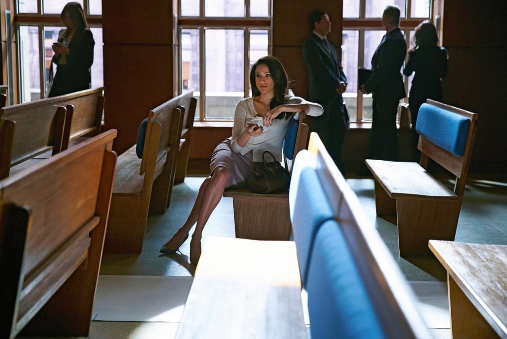 A still from ‘Suits' that shows Meghan Markle as Rachel Zane sitting alone in a pew