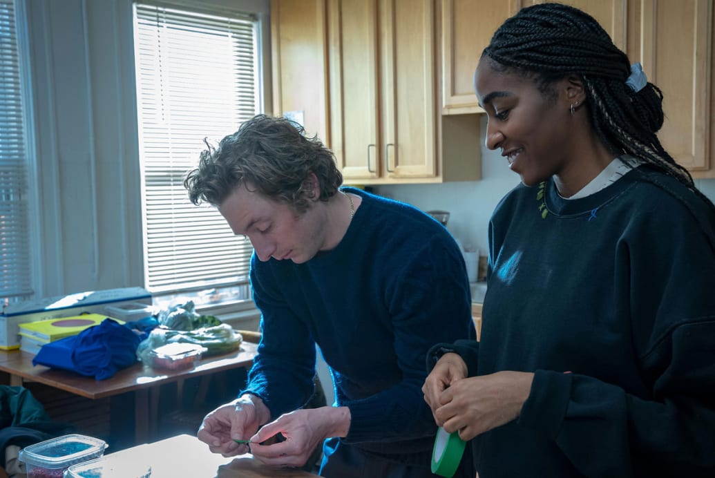 Jeremy Allen White and Ayo Edebiri prepare food in a kitchen in a still from ‘The Bear’