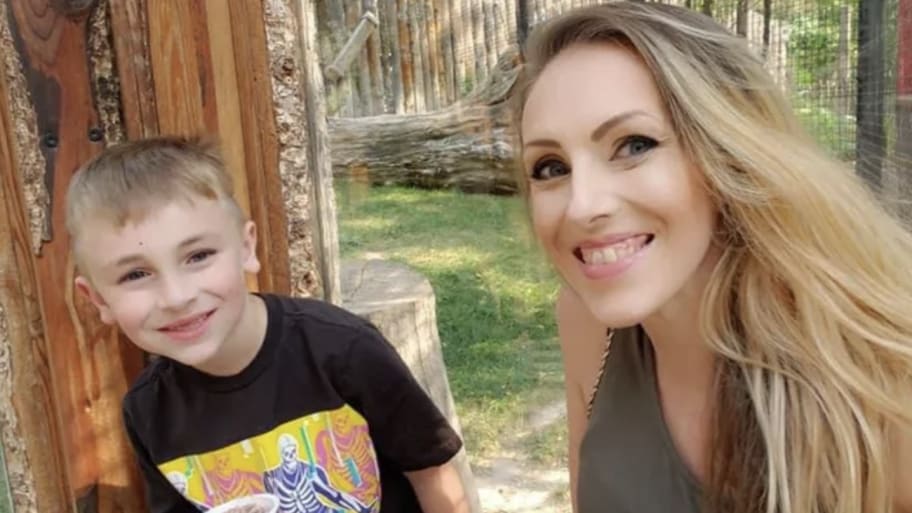 Emily Carroll and her son, Kellan, smile together. Cops say two were attacked by a pack of dogs on Saturday that killed Kellan and severely injured Emily. 