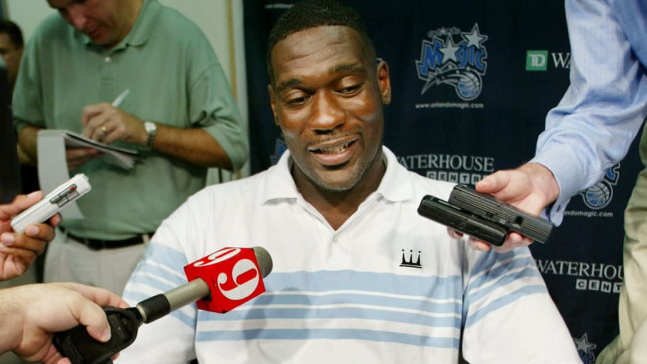 Shawn Kemp answers questions at a press conference.