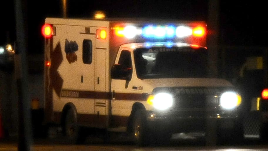 An ambulance drives at night
