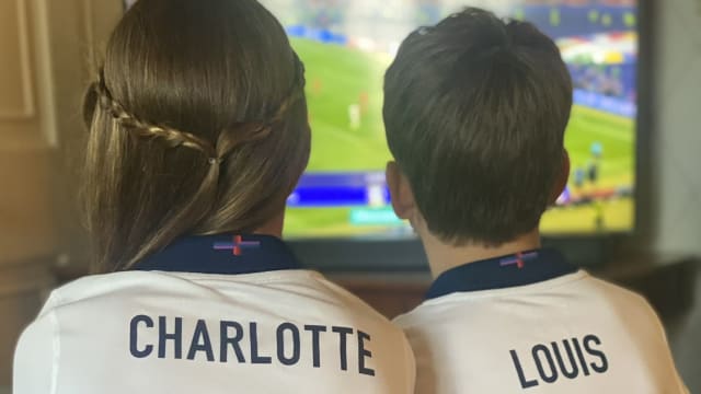 Charlotte and Louis watch the football.