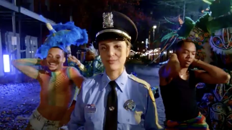 A New Orleans Police Officer with Mardi Gras performers