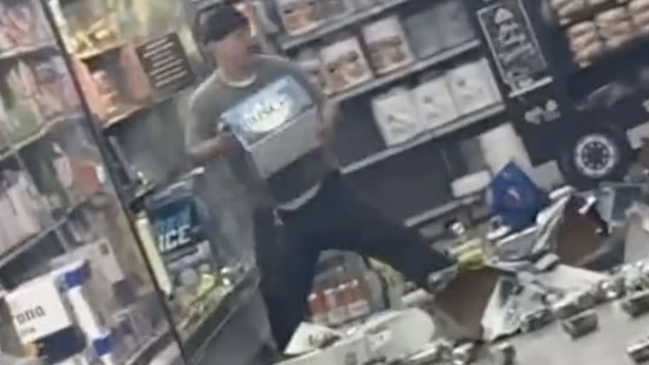 J Dustin D. Cain destroying beer in a Walmart in Topeka, Kansas.