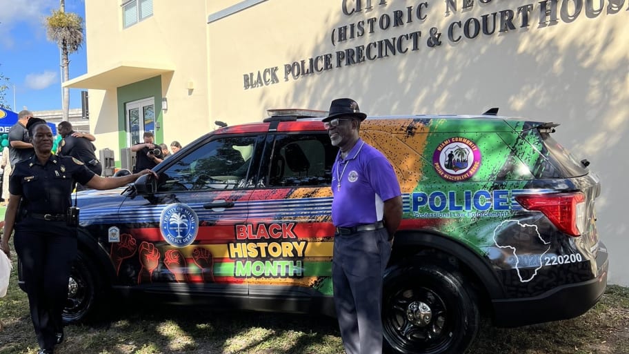 Members of the Miami Police Department reveal their Black History Month-themed police cruiser at an event in Miami on Thursday.