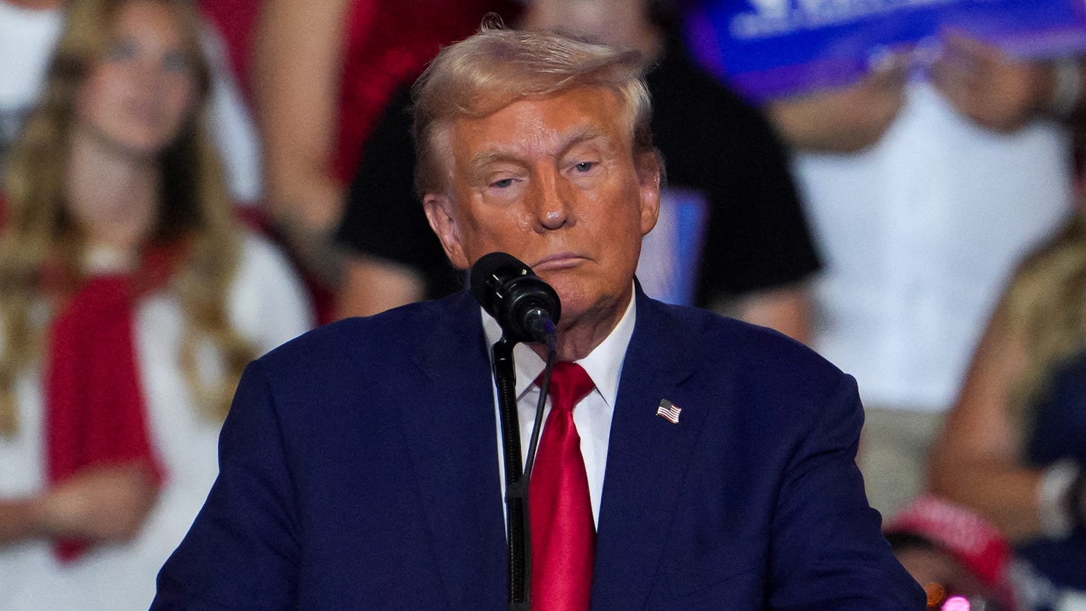 Donald Trump stares forward blankly during a campaign rally.