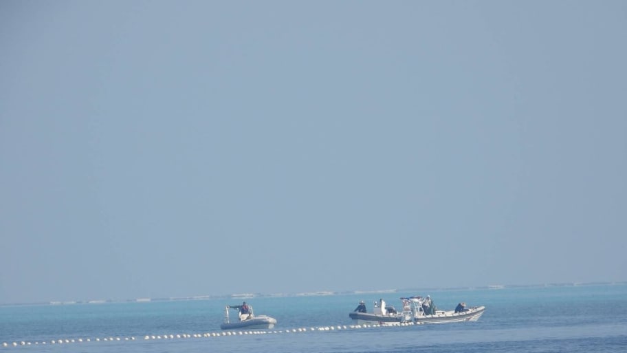 Chinese Coast Guard boats close to the floating barrier near the Scarborough Shoal.