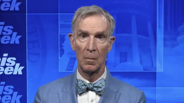 Bill Nye stares forward during a TV interview.