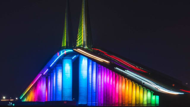 Rainbow colors illuminate the Sunshine Skyway Bridge in Florida.