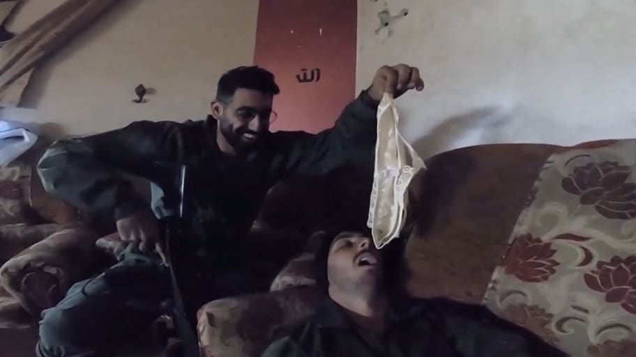 An Israeli soldier holds underwear over the face of a fellow Israeli soldier in a screengrab from a video obtained by Reuters.