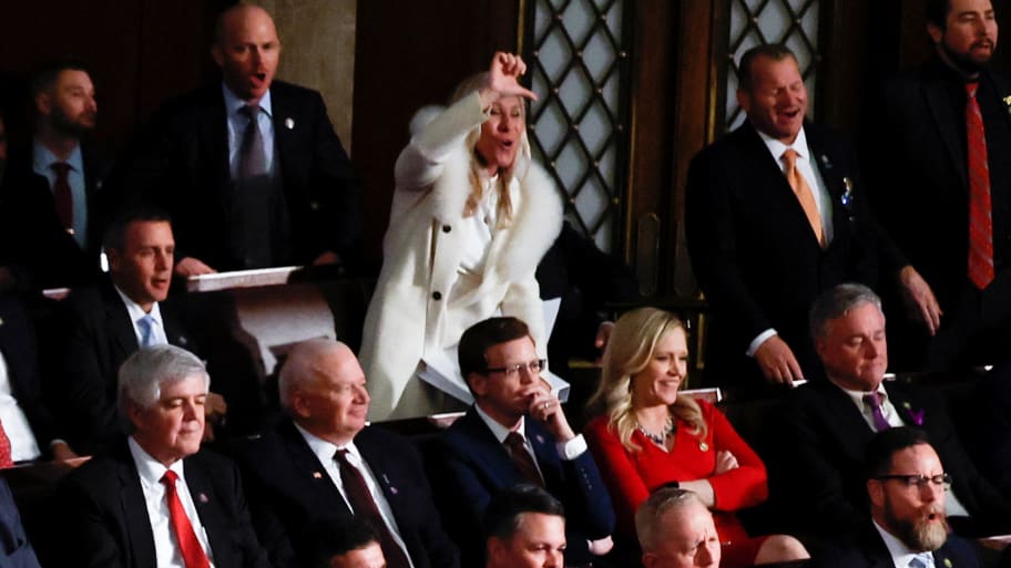 U.S. Representative Marjorie Taylor Greene (R-GA) gives a thumbs down and yells at U.S. President Joe Biden, as he delivers his State of the Union