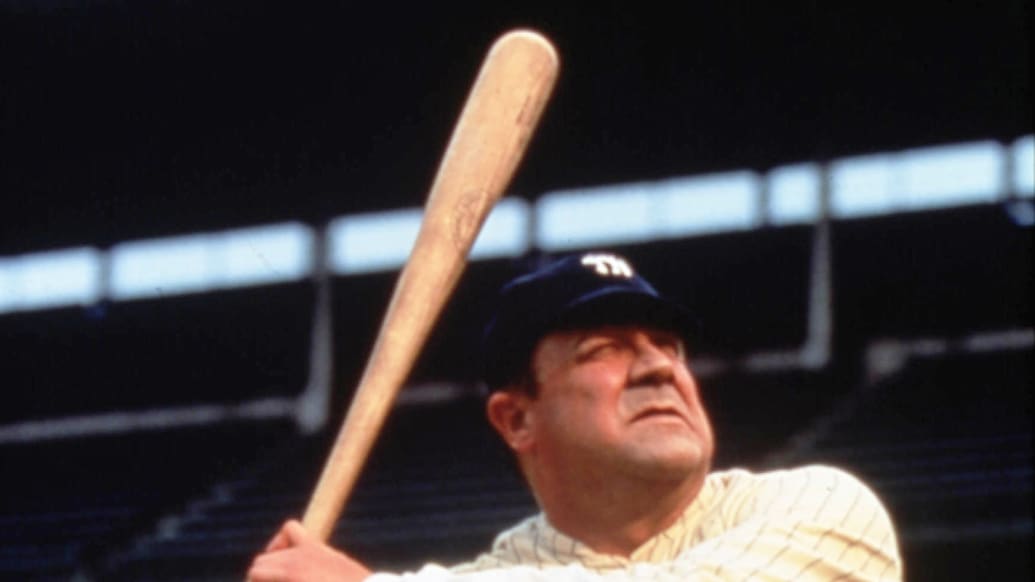 Babe Ruth in baseball uniform standing in dugout Stock Photo - Alamy