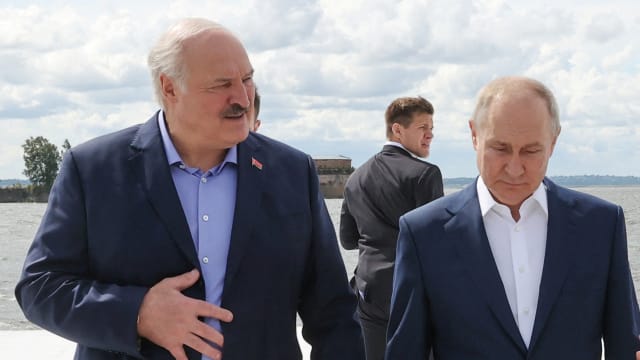 Russian President Vladimir Putin and Belarusian President Alexander Lukashenko walk together in Russia. 