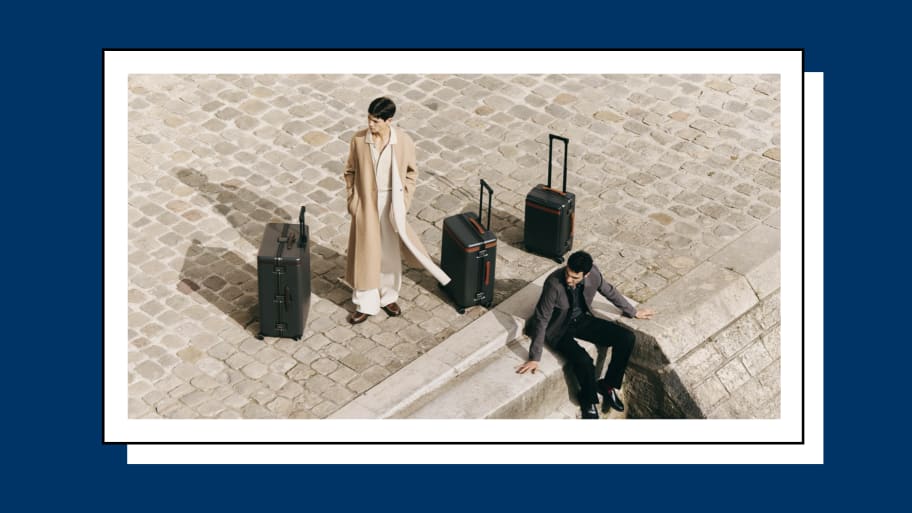 Two men posing near a suitcase set from Carl Friedrik.