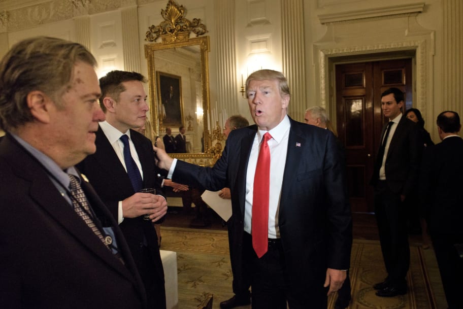 Trump advisor Steve Bannon watches as US President Donald Trump greets Elon Musk